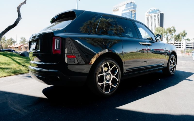 Rolls-Royce Cullinan Side View With Hotels In The Background