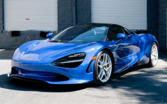 Blue McLaren 720 exotic supercar rental parked outside Dream Exotics Miami available for luxury car experiences in Miami