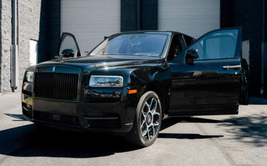 Black Rolls-Royce Cullinan luxury SUV rental with open doors available from Dream Exotics Miami in Fort Lauderdale and Miami